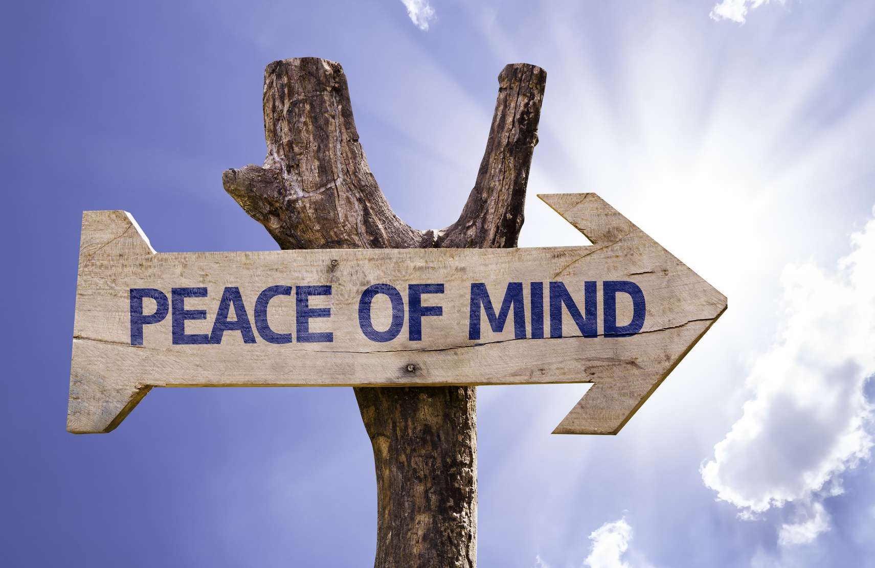 Peace of Mind wooden sign with a sky background