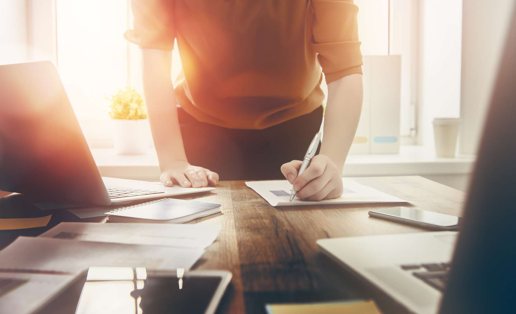 business woman signing documents